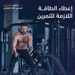 Man exercising with battle ropes in a gym setting